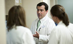 Dr. Ramsay Camp discusses a case with colleagues